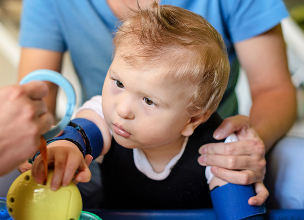 a tall cylindrical object with a narrow top and horizontal lines resembling six sections or bands representing a minimalist design